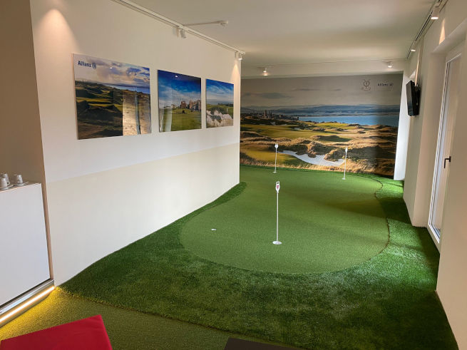 Charlotte indoor putting green in an office with scenic wall art